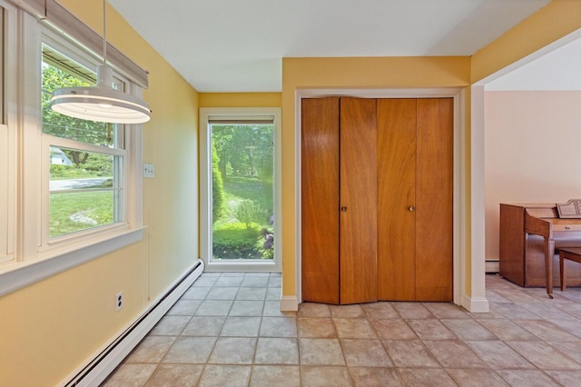 24 High St, Hallowell, ME 04347 - foyer featuring baseboard heating, healthy amount of natural light, and light stone finish floors