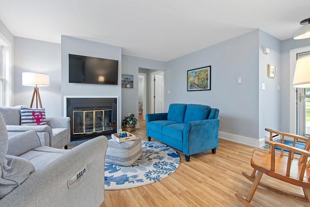 65 Pine Point Rd Unit 7, Scarborough, ME 04074 - living area with light wood finished floors and a glass covered fireplace