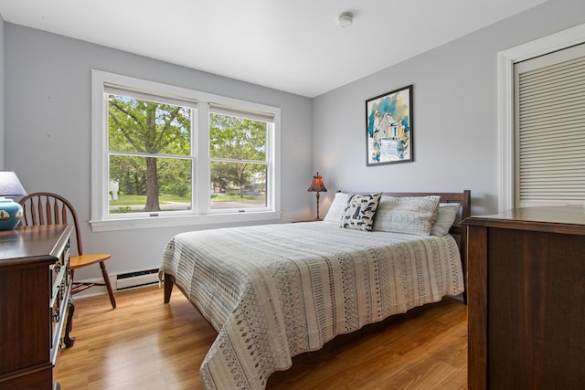 65 Pine Point Rd Unit 7, Scarborough, ME 04074 - bedroom featuring light wood-type flooring and a baseboard heating unit