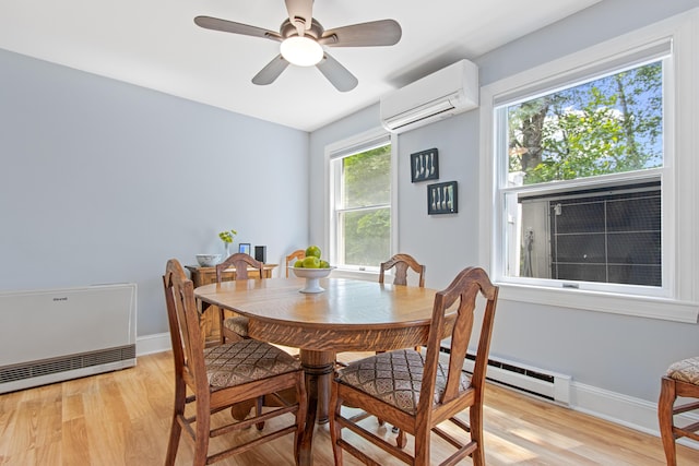 65 Pine Point Rd Unit 7, Scarborough, ME 04074 - dining room with a wall mounted air conditioner, baseboard heating, light wood finished floors, and ceiling fan