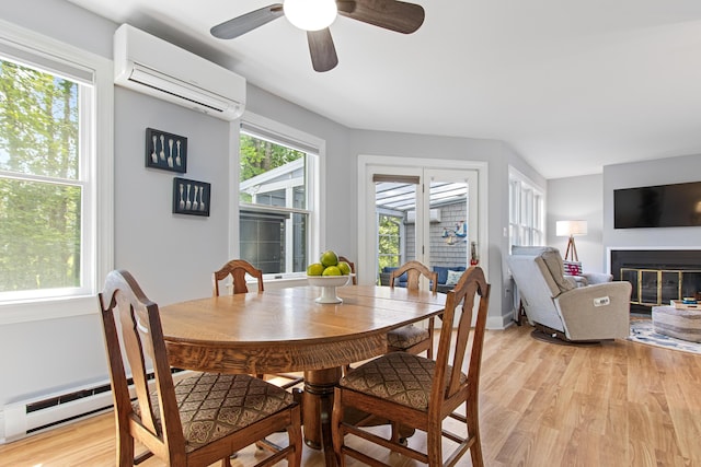 65 Pine Point Rd Unit 7, Scarborough, ME 04074 - dining space featuring a wall mounted AC, light wood-style flooring, a ceiling fan, and a glass covered fireplace
