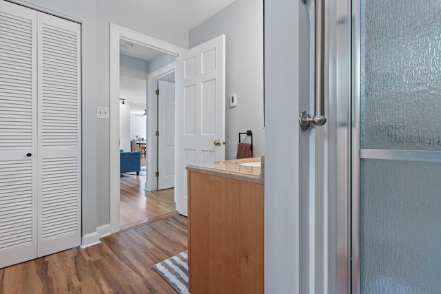65 Pine Point Rd Unit 7, Scarborough, ME 04074 - bathroom featuring wood finished floors, a closet, and vanity