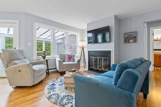 65 Pine Point Rd Unit 7, Scarborough, ME 04074 - living area with light wood finished floors, a baseboard heating unit, and a fireplace with flush hearth