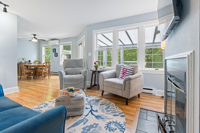 65 Pine Point Rd Unit 7, Scarborough, ME 04074 - living room featuring a wall unit AC, baseboard heating, light wood-style flooring, and healthy amount of natural light