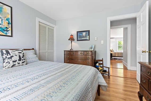 65 Pine Point Rd Unit 7, Scarborough, ME 04074 - bedroom with light wood-style flooring, a closet, and radiator heating unit