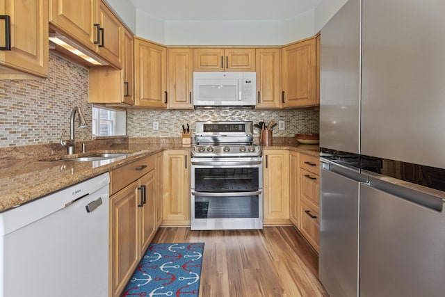 65 Pine Point Rd Unit 7, Scarborough, ME 04074 - kitchen with appliances with stainless steel finishes, light stone countertops, light wood-style floors, and backsplash