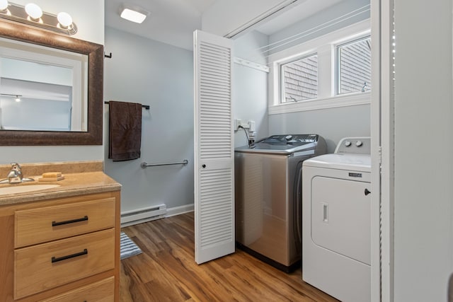 65 Pine Point Rd Unit 7, Scarborough, ME 04074 - laundry room featuring baseboard heating, separate washer and dryer, and light wood-type flooring