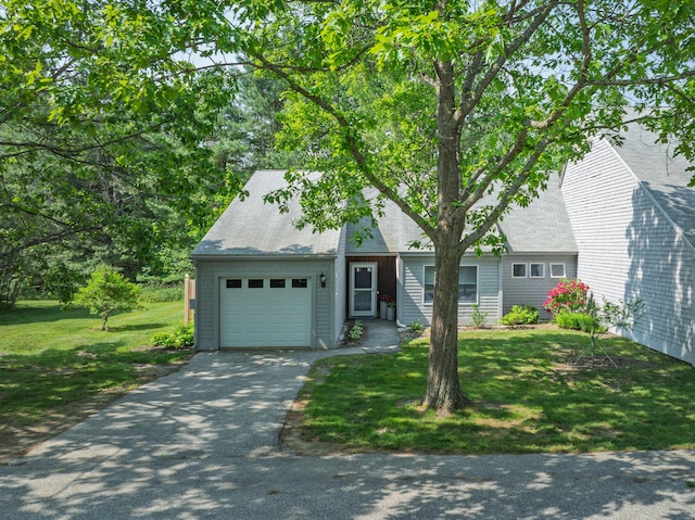 65 Pine Point Rd Unit 7, Scarborough, ME 04074 - view of front facade featuring a garage, driveway, a front yard, and a shingled roof