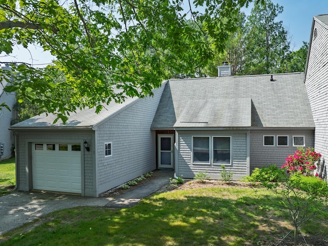65 Pine Point Rd Unit 7, Scarborough, ME 04074 - view of front of property featuring an attached garage, a chimney, driveway, and a front lawn