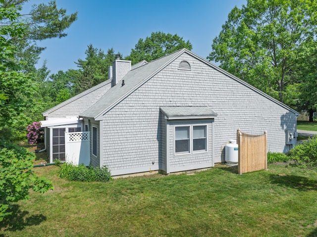 65 Pine Point Rd Unit 7, Scarborough, ME 04074 - back of house with a chimney and a yard