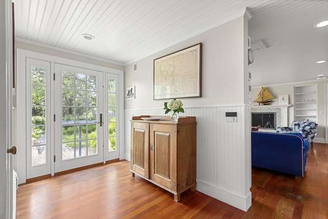 8 Broad Cove Rd, Cape Elizabeth, ME 04107 - doorway with wainscoting, hardwood / wood-style flooring, crown molding, and a fireplace