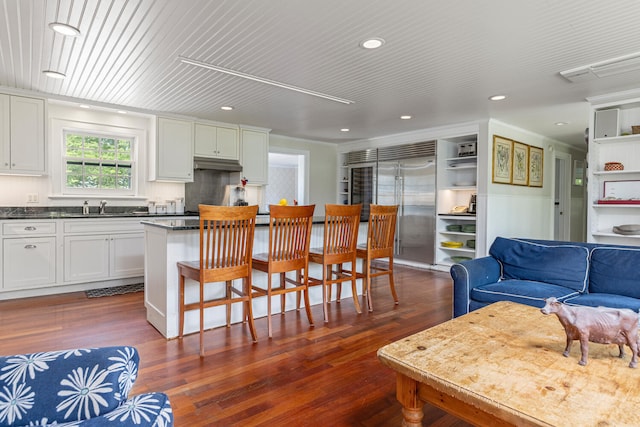 8 Broad Cove Rd, Cape Elizabeth, ME 04107 - kitchen with stainless steel built in fridge, dark countertops, white cabinetry, dark wood finished floors, and recessed lighting