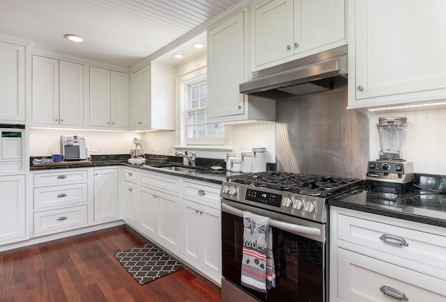 8 Broad Cove Rd, Cape Elizabeth, ME 04107 - kitchen with stainless steel gas range, under cabinet range hood, dark wood-style flooring, white cabinetry, and recessed lighting