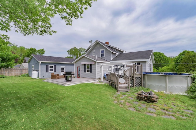 16 Lawn Ave, Rockland, ME 04841 - rear view of house with an outdoor fire pit, a deck, and a chimney