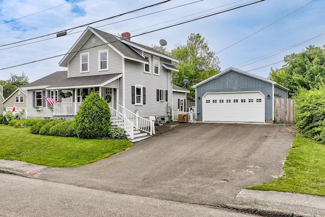 16 Lawn Ave, Rockland, ME 04841 - view of front of property with a detached garage, a shingled roof, covered porch, an outdoor structure, and a chimney