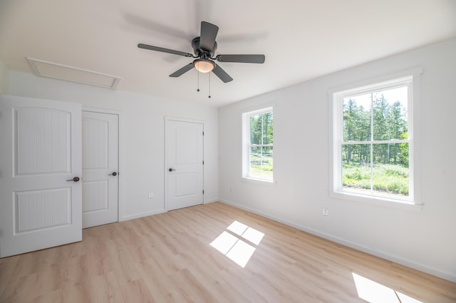 6 Walker Rd, Embden, ME 04958 - unfurnished bedroom featuring light wood-style flooring, baseboards, and attic access
