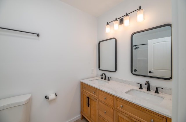 6 Walker Rd, Embden, ME 04958 - bathroom featuring double vanity, toilet, baseboards, and a shower
