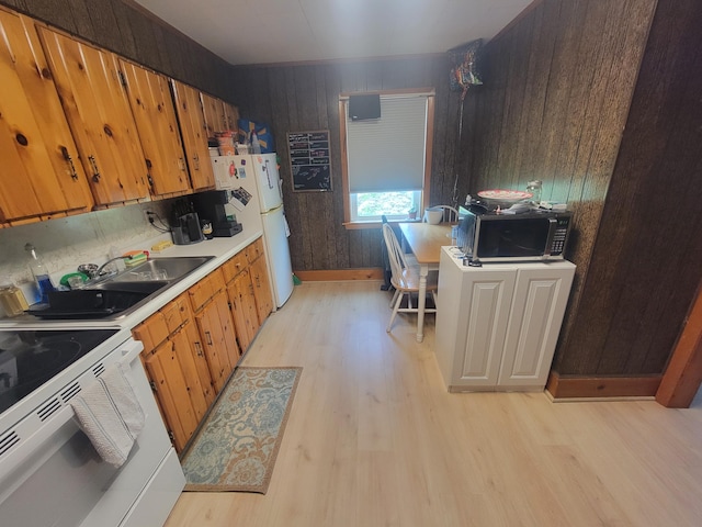 185 Elm St, Brewer, ME 04412 - kitchen featuring white appliances, light wood-style flooring, wooden walls, light countertops, and brown cabinets