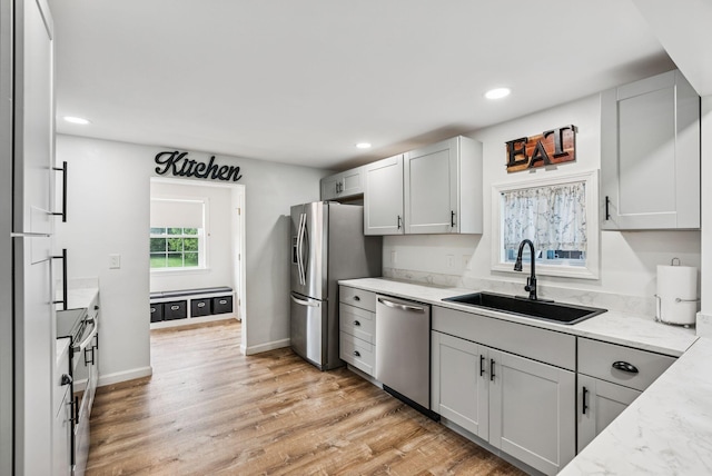 15 Bernard Ave, Biddeford, ME 04005 - kitchen featuring stainless steel appliances, a sink, recessed lighting, light stone counters, and light wood-type flooring