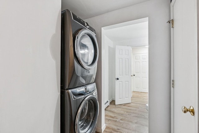 15 Bernard Ave, Biddeford, ME 04005 - laundry area featuring estacked washer and dryer, a baseboard heating unit, light wood-style floors, and baseboards