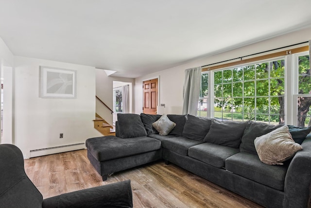 15 Bernard Ave, Biddeford, ME 04005 - living room with a baseboard radiator, stairs, and wood finished floors
