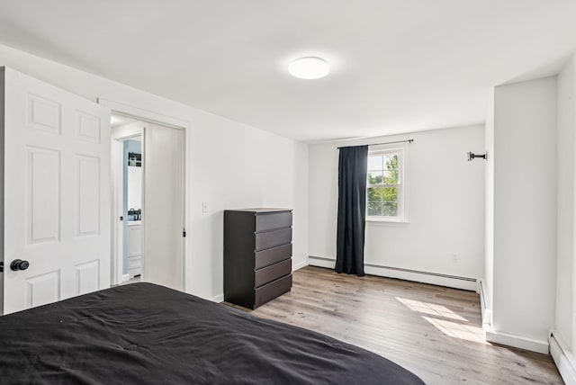 15 Bernard Ave, Biddeford, ME 04005 - bedroom with wood finished floors, a baseboard heating unit, and baseboards