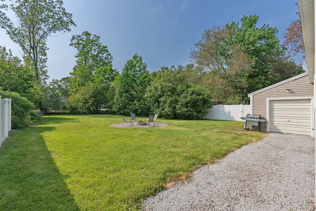 15 Bernard Ave, Biddeford, ME 04005 - view of yard featuring a garage, an outdoor fire pit, and gravel driveway