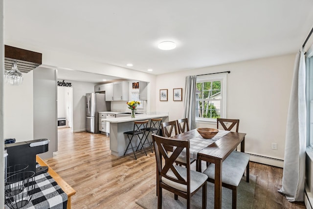 15 Bernard Ave, Biddeford, ME 04005 - dining room with a baseboard heating unit, light wood-style flooring, and recessed lighting