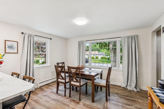 15 Bernard Ave, Biddeford, ME 04005 - dining space with a baseboard radiator, light wood-style flooring, and baseboards