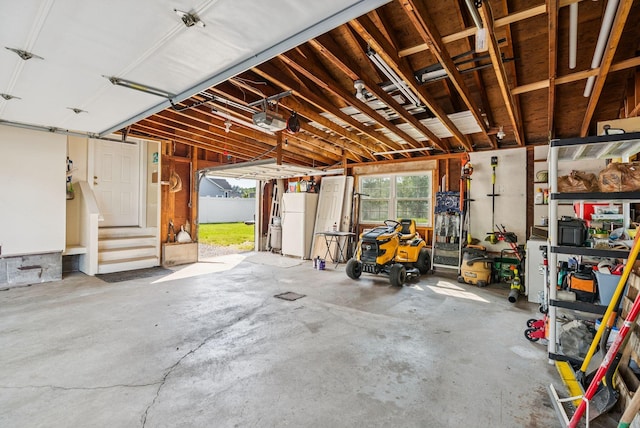 15 Bernard Ave, Biddeford, ME 04005 - garage with freestanding refrigerator and a garage door opener