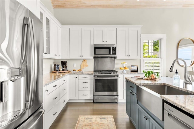 48 Ocean St, Belfast, ME 04915 - kitchen with appliances with stainless steel finishes, glass insert cabinets, wood finished floors, and white cabinets