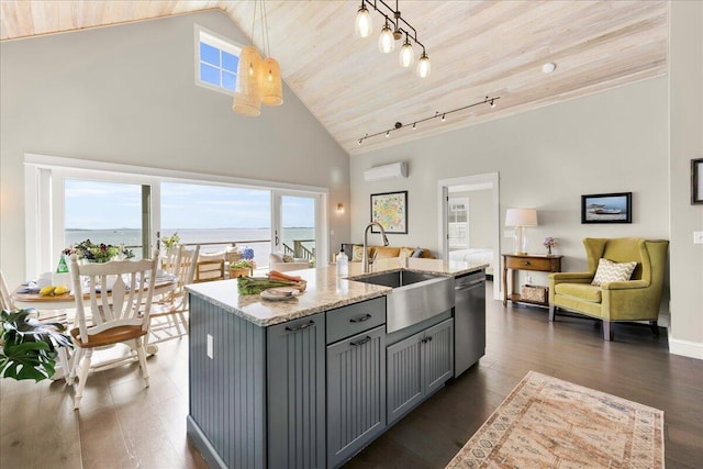 48 Ocean St, Belfast, ME 04915 - kitchen featuring gray cabinetry, stainless steel dishwasher, an AC wall unit, light stone countertops, and high vaulted ceiling