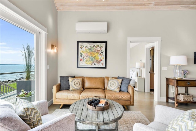 48 Ocean St, Belfast, ME 04915 - living room featuring a wall mounted air conditioner, healthy amount of natural light, a water view, and wood finished floors