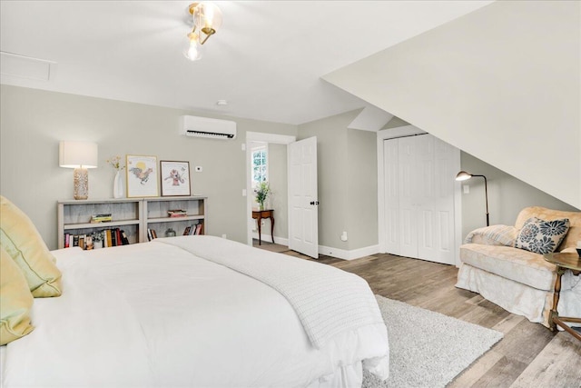 48 Ocean St, Belfast, ME 04915 - bedroom featuring a wall mounted air conditioner, wood finished floors, and a closet