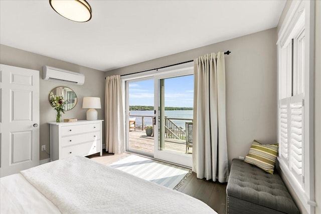 48 Ocean St, Belfast, ME 04915 - bedroom with a wall mounted air conditioner, access to outside, a water view, and wood finished floors