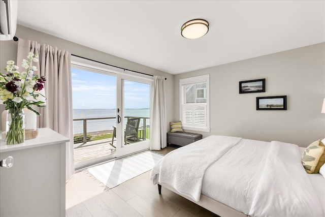 48 Ocean St, Belfast, ME 04915 - bedroom featuring a water view, access to exterior, and wood finished floors