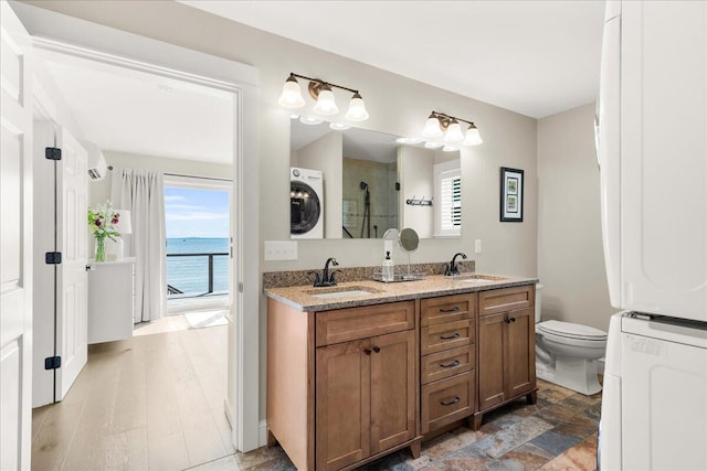48 Ocean St, Belfast, ME 04915 - full bath featuring healthy amount of natural light, stacked washing machine and dryer, an enclosed shower, and double vanity