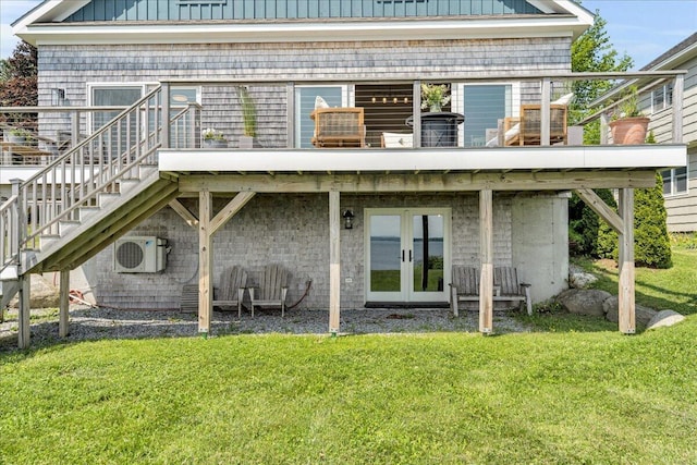 48 Ocean St, Belfast, ME 04915 - rear view of property featuring french doors, stairway, a lawn, and board and batten siding