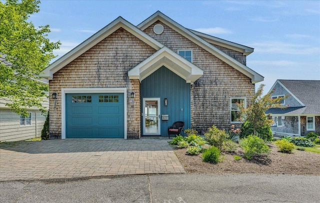 48 Ocean St, Belfast, ME 04915 - view of front of home featuring board and batten siding, an attached garage, and driveway