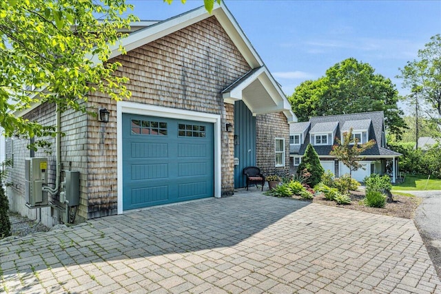48 Ocean St, Belfast, ME 04915 - shingle-style home with decorative driveway and an attached garage