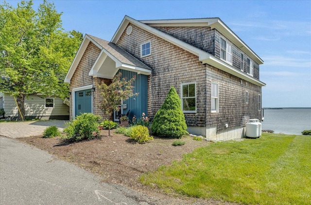 48 Ocean St, Belfast, ME 04915 - view of front of home featuring a garage, a water view, a front yard, and driveway