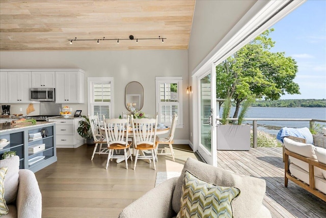 48 Ocean St, Belfast, ME 04915 - dining space featuring rail lighting, wooden ceiling, light wood finished floors, a water view, and vaulted ceiling