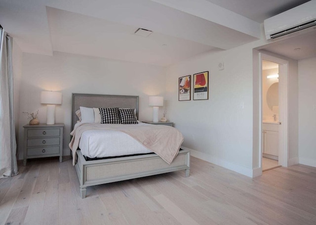 387 Commercial St Unit 527, Portland, ME 04101 - bedroom featuring a wall mounted AC and light wood-style floors