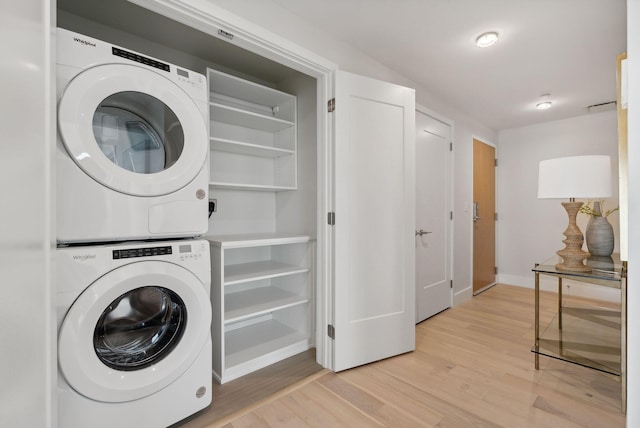 387 Commercial St Unit 527, Portland, ME 04101 - laundry area with stacked washer / dryer and light wood-type flooring