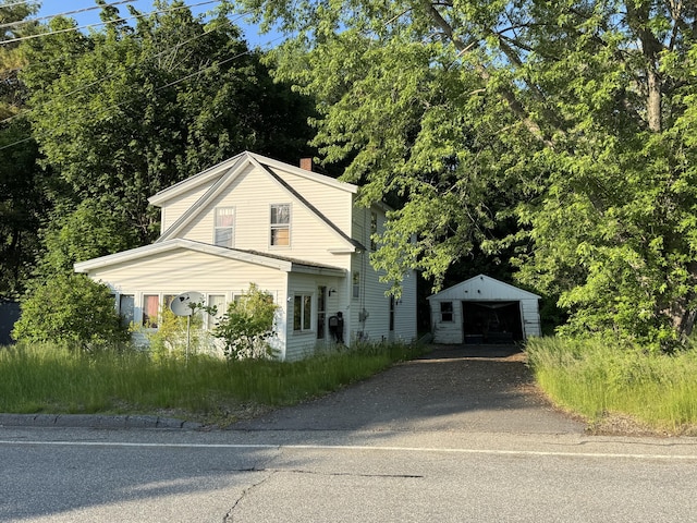 23 Hicks Rd, Augusta, ME 04330 - view of front of home featuring a garage, an outbuilding, driveway, and a chimney