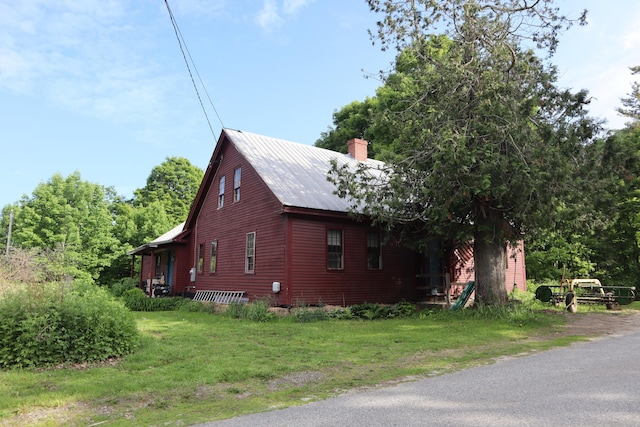 95 Wiley Rd, Greene, ME 04236 - view of side of home with a chimney and metal roof