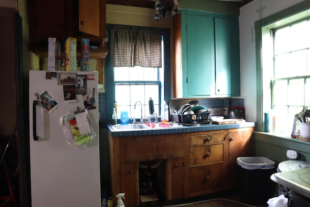 95 Wiley Rd, Greene, ME 04236 - kitchen featuring freestanding refrigerator, a sink, plenty of natural light, and backsplash