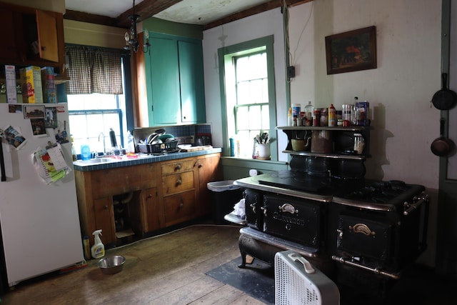 95 Wiley Rd, Greene, ME 04236 - kitchen with freestanding refrigerator, hardwood / wood-style flooring, a sink, decorative backsplash, and brown cabinets