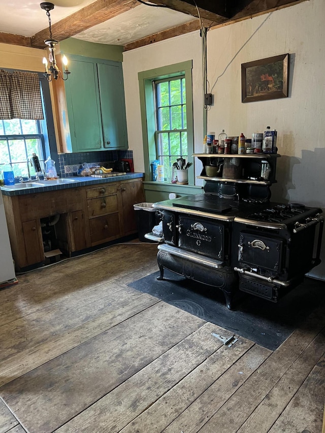 95 Wiley Rd, Greene, ME 04236 - kitchen with dark wood-type flooring, black range oven, a chandelier, dark countertops, and backsplash