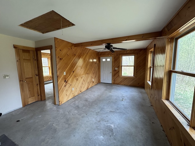 47 Witham Ln, Augusta, ME 04330 - empty room featuring attic access, wood walls, unfinished concrete flooring, beamed ceiling, and a baseboard radiator